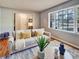 Bright living room featuring hardwood floors, a large window, and neutral-toned furniture at 5470 Chanterella Sw Ct, Lilburn, GA 30047