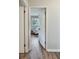 View into the living room featuring an accent chair and hardwood style flooring at 5470 Chanterella Sw Ct, Lilburn, GA 30047