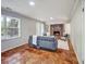 Bright living room showcases a brick fireplace, stylish furniture, and unique tile flooring at 5470 Chanterella Sw Ct, Lilburn, GA 30047