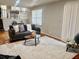 Open living room with a comfortable gray couch and a bright, neutral rug at 5470 Chanterella Sw Ct, Lilburn, GA 30047