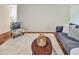 This comfortable living room includes a modern sofa, area rug, and natural lighting at 5470 Chanterella Sw Ct, Lilburn, GA 30047