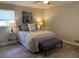 Bright bedroom with stylish lamps, bench, decor art, and plush bedding at 5470 Chanterella Sw Ct, Lilburn, GA 30047
