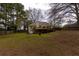 Spacious backyard with lush grass, a deck, and a two-story home at 10 Flowers Dr, Covington, GA 30014