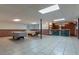 Basement featuring a bar and two pool tables with a tile floor at 10 Flowers Dr, Covington, GA 30014