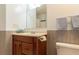 Bathroom featuring a wooden vanity, sink, mirror, and white toilet at 10 Flowers Dr, Covington, GA 30014