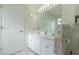 Bathroom featuring double sinks, a big mirror, and white cabinets at 10 Flowers Dr, Covington, GA 30014