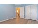 Light blue bedroom with a double closet, plush floors, and bright doorway at 10 Flowers Dr, Covington, GA 30014
