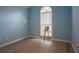Blue bedroom with a high ceiling, decorative window, and plush flooring at 10 Flowers Dr, Covington, GA 30014