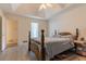 Bedroom with a bed, tray ceiling, ceiling fan, and door to another room at 10 Flowers Dr, Covington, GA 30014