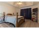 Bedroom with a large bed, wood floors, a tray ceiling, and a ceiling fan at 10 Flowers Dr, Covington, GA 30014