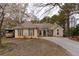 Charming one-story home with a mix of neutral siding, stone accents, and a well-manicured lawn at 10 Flowers Dr, Covington, GA 30014
