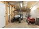Unfinished garage with room for a golf cart, lawn mower, and storage at 10 Flowers Dr, Covington, GA 30014