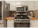 Updated kitchen with stainless steel appliances, wood countertops, and white cabinets at 10 Flowers Dr, Covington, GA 30014