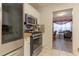 Modern kitchen with stainless steel appliances and a view into the adjacent office space at 10 Flowers Dr, Covington, GA 30014