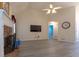 Bright living room featuring vaulted ceilings, a stone fireplace, and a large television at 10 Flowers Dr, Covington, GA 30014