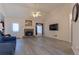 Bright living room with a stone fireplace, high ceilings, ceiling fan, and neutral walls at 10 Flowers Dr, Covington, GA 30014