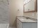 Bathroom featuring a granite countertop, mirror, and stylish backsplash at 1248 W Ridge Ave, Stone Mountain, GA 30083