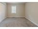 This bedroom is carpeted and has a closet and a large window at 1248 W Ridge Ave, Stone Mountain, GA 30083