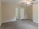 This bedroom is carpeted and features a ceiling fan and an open door to another room at 1248 W Ridge Ave, Stone Mountain, GA 30083