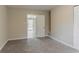 Carpeted bedroom with an open door that leads to another room at 1248 W Ridge Ave, Stone Mountain, GA 30083