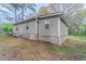 Side view of house with painted foundation and central air unit at 1248 W Ridge Ave, Stone Mountain, GA 30083