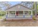 Charming single-story home with a cozy front porch and a red front door at 1248 W Ridge Ave, Stone Mountain, GA 30083