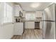 Modern kitchen features stainless steel appliances and white cabinetry at 1248 W Ridge Ave, Stone Mountain, GA 30083