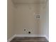 A compact laundry area with utility connections and shelving for organized storage solutions at 1248 W Ridge Ave, Stone Mountain, GA 30083
