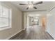 Open-concept living area with modern light fixture, hardwood flooring, and natural light at 1248 W Ridge Ave, Stone Mountain, GA 30083