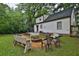 A lovely backyard with a fire pit area, seating, green grass and mature trees offering shade at 2344 Johnson Ferry Ne Rd, Atlanta, GA 30341