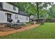 Spacious backyard featuring a deck with a grill, a fire pit area, and green grass at 2344 Johnson Ferry Ne Rd, Atlanta, GA 30341