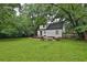 A spacious backyard with a fire pit, seating area, and lush green grass, perfect for outdoor activities at 2344 Johnson Ferry Ne Rd, Atlanta, GA 30341