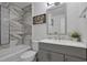 Beautiful bathroom with a bathtub with designer tile, a gray vanity, and a modern framed mirror at 2344 Johnson Ferry Ne Rd, Atlanta, GA 30341