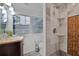 Modern bathroom featuring a marble shower, a window, and a vanity with solid surface countertop at 2344 Johnson Ferry Ne Rd, Atlanta, GA 30341