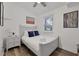 Bright bedroom with a full-sized bed, nightstand, modern art, and light gray walls at 2344 Johnson Ferry Ne Rd, Atlanta, GA 30341
