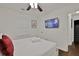 Cozy bedroom with white bedding and walls, and a wall-mounted TV at 2344 Johnson Ferry Ne Rd, Atlanta, GA 30341