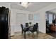 Bright dining area with black table set, modern chandelier, and views into the living room at 2344 Johnson Ferry Ne Rd, Atlanta, GA 30341