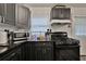 This spacious kitchen has black cabinets, stainless steel appliances, and granite countertops at 2344 Johnson Ferry Ne Rd, Atlanta, GA 30341