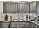 Kitchen featuring dark cabinetry, stainless steel appliances, and tile backsplash at 2344 Johnson Ferry Ne Rd, Atlanta, GA 30341