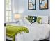 Cozy bedroom with decorative pillows, white bedding, and plenty of natural light at 2535 Judson Ave, East Point, GA 30344