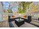 Outdoor deck with comfortable seating and a glass coffee table, perfect for relaxation at 2535 Judson Ave, East Point, GA 30344