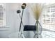 Cozy dining area with modern decor featuring a sleek black floor lamp and decorative vase on a glass table at 2535 Judson Ave, East Point, GA 30344
