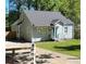 Charming home with light blue siding, a well-manicured lawn, and a cozy front porch at 2535 Judson Ave, East Point, GA 30344