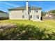 Large backyard features a green lawn, wood fence, and rear view of the home's vinyl siding at 4244 Old House Dr, Conley, GA 30288