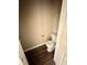 Compact half-bathroom featuring wood-look floors, and a modern toilet at 4244 Old House Dr, Conley, GA 30288