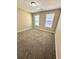 A bedroom with carpeted flooring and two windows offering natural light at 4244 Old House Dr, Conley, GA 30288