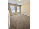 A bedroom with carpeted flooring and two windows offering natural light at 4244 Old House Dr, Conley, GA 30288