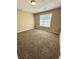 Bedroom features neutral walls, carpeted flooring and a window with natural light at 4244 Old House Dr, Conley, GA 30288