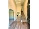 Inviting foyer with hardwood floors, leading to a carpeted staircase and living spaces at 4244 Old House Dr, Conley, GA 30288