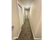 Carpeted hallway with neutral walls, leading to other areas of the home at 4244 Old House Dr, Conley, GA 30288
